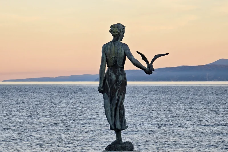 The Maiden with the Seagull statue on the Opatija seafront at dusk